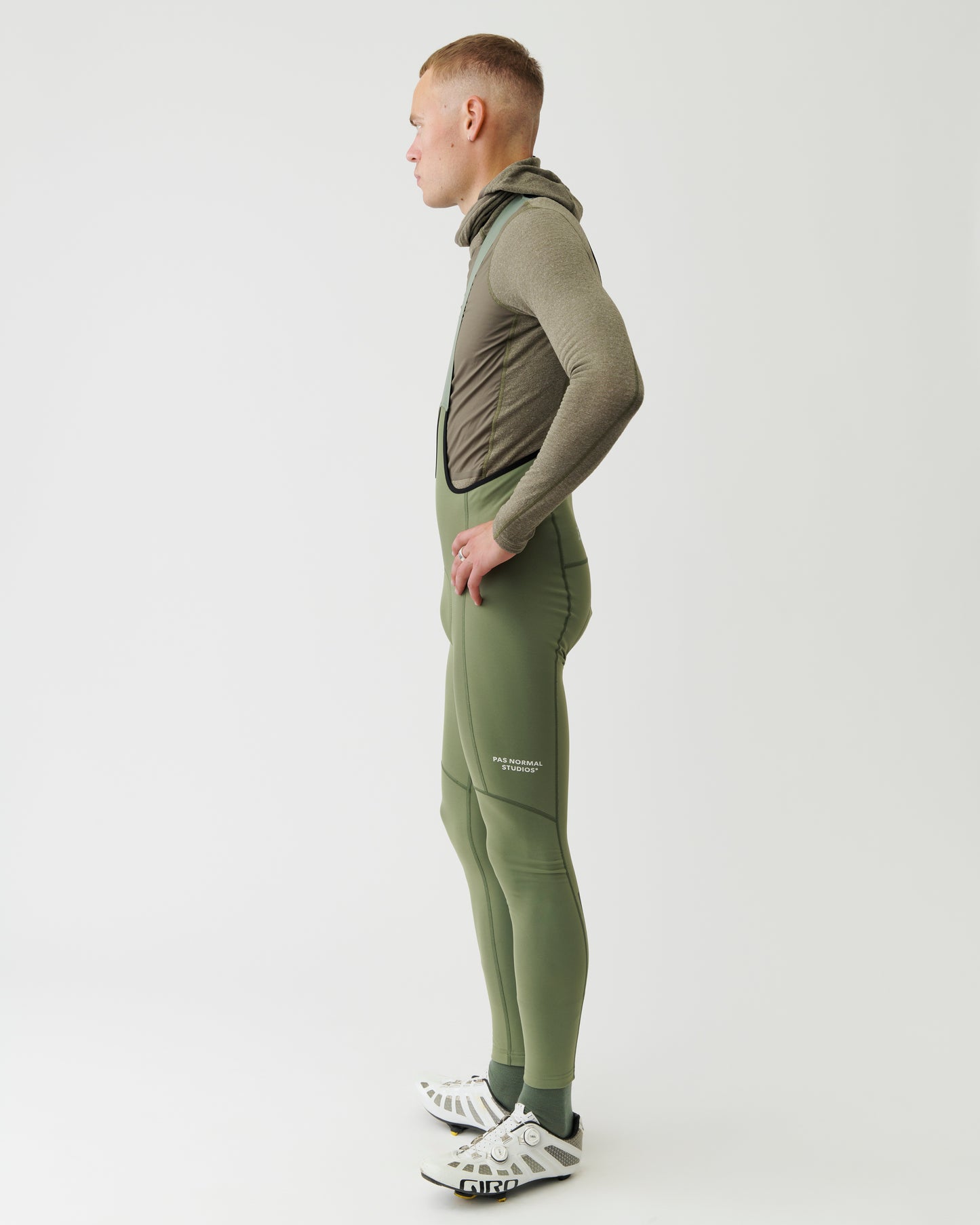 Person wearing a green tracksuit with a white background