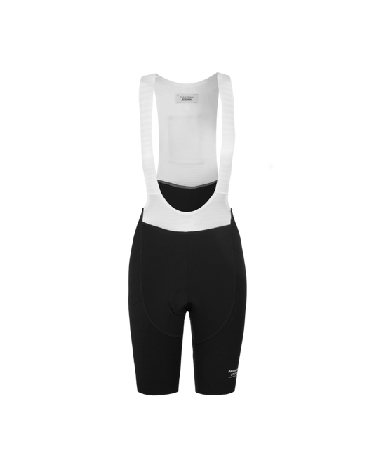 A pair of women's bib shorts in black color with white straps, designed for cycling.