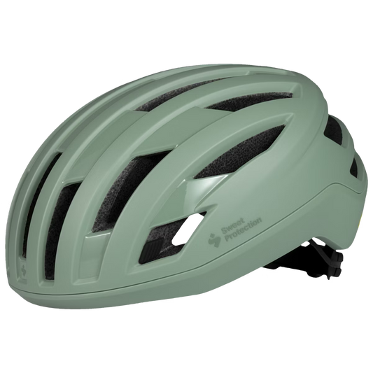 A green Sweet Protection Fluxer MIPS helmet designed for cycling, showing side and front views.