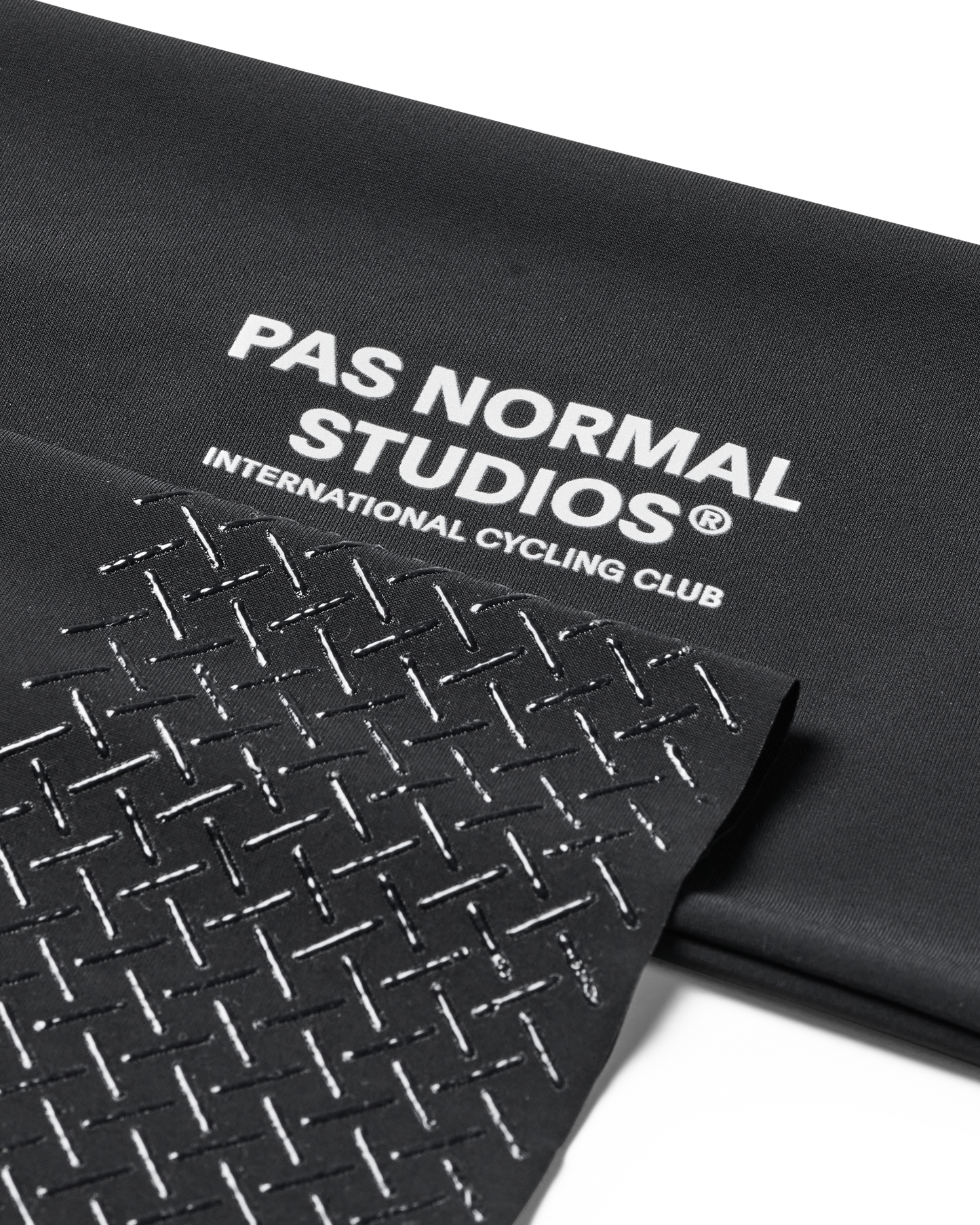 Black mat with 'Pas Normal Studios' branding on a white background