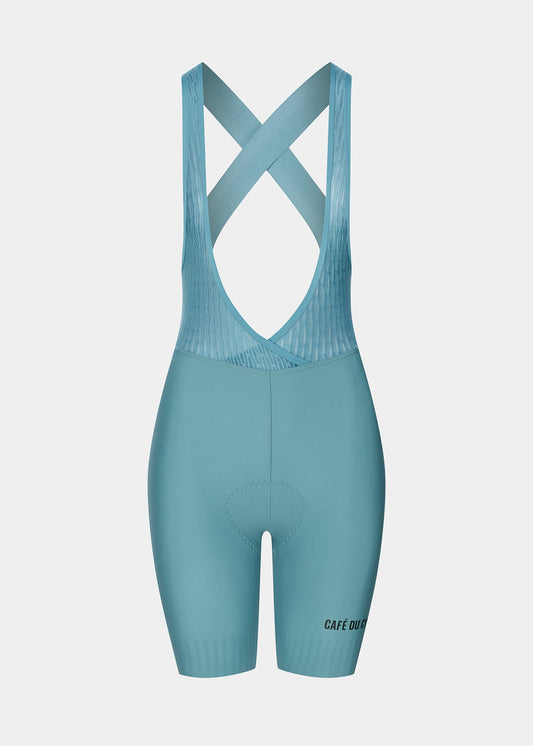 A pair of women's bib shorts in a solid deep water blue color, with premium four-density female chamois and a quick-release design.