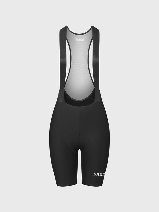 Women's black bib shorts with shoulder straps and a small logo on the left thigh area.