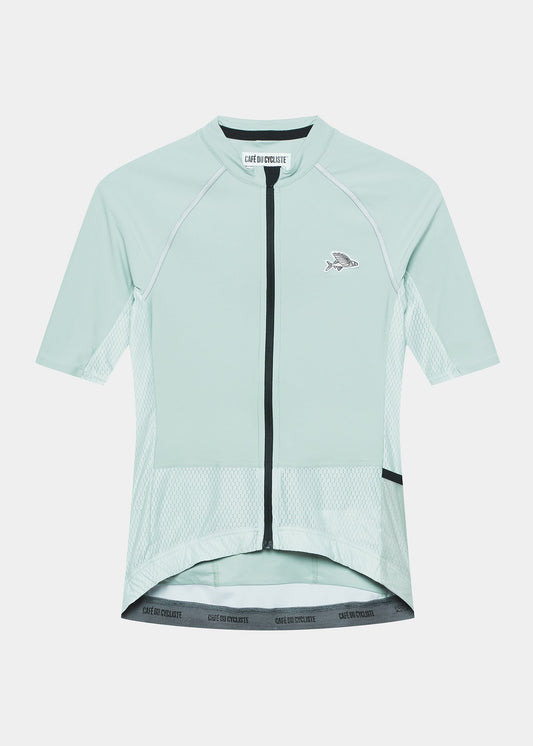 A women's cycling jersey in jadeite green with a front zipper and a longer back hem.