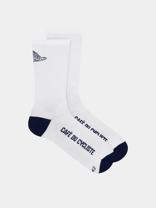A pair of white cycling socks with a flying fish motif and text 'CAFE DU CYCListe' on the side.