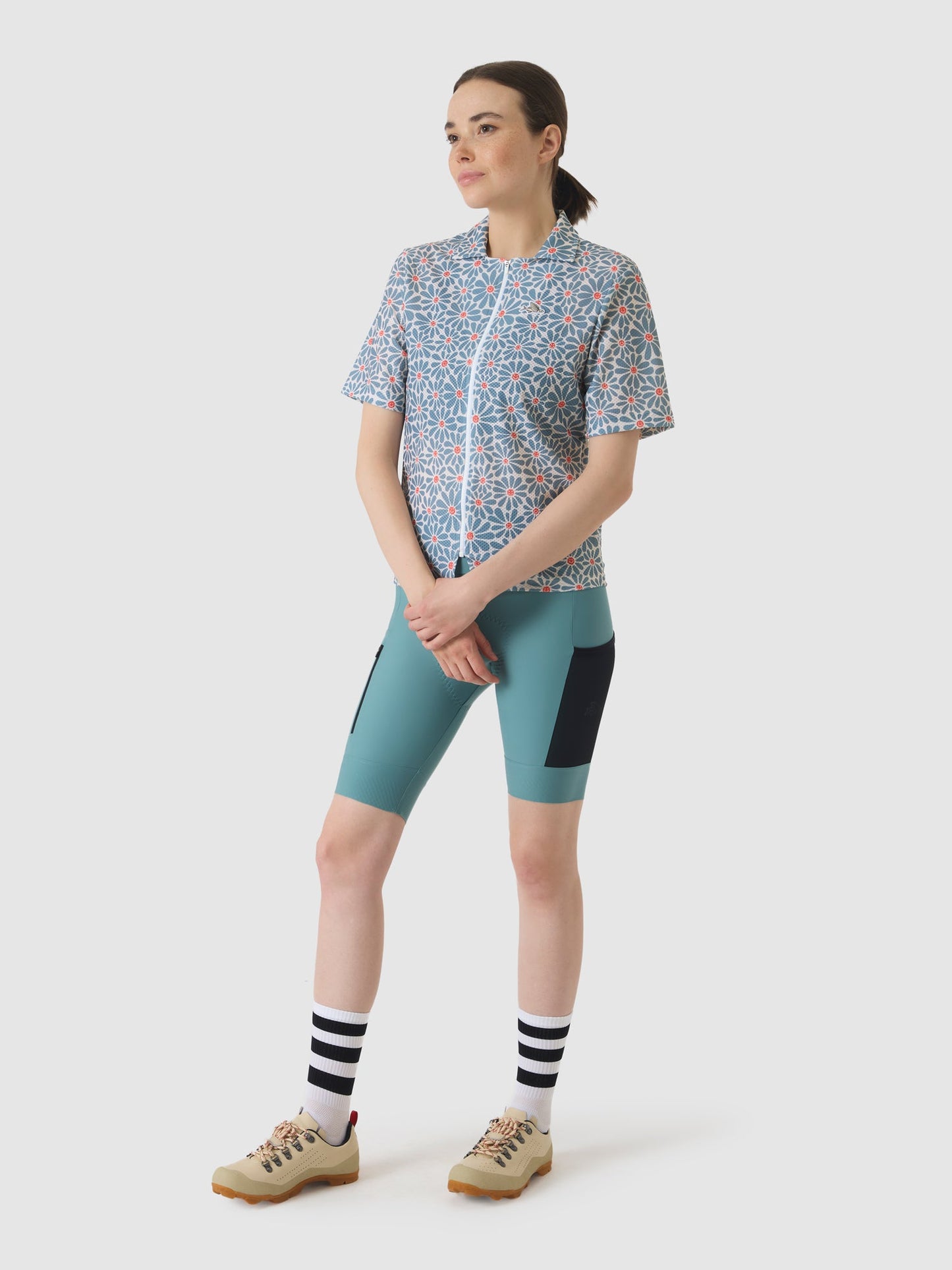 Model wearing Claudine Shirt with daisy print and deep water hues.
