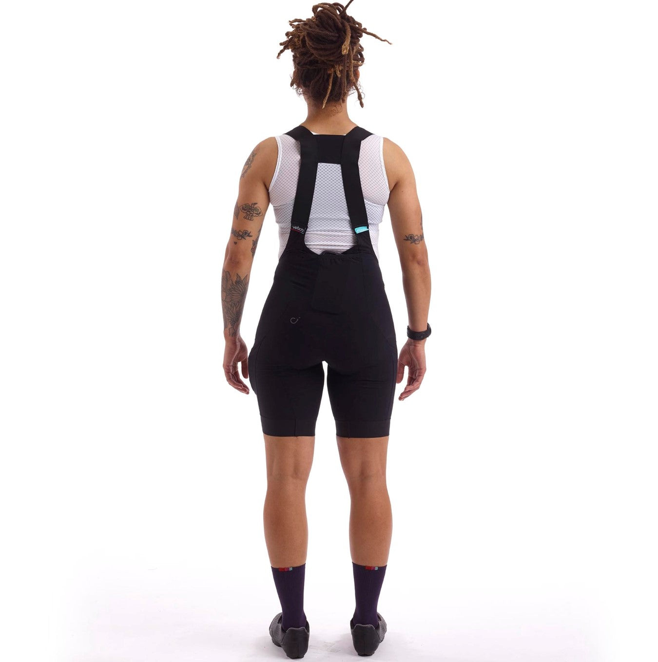 Stylish black bib shorts with reflective detailing, ensuring visibility during low-light riding conditions.