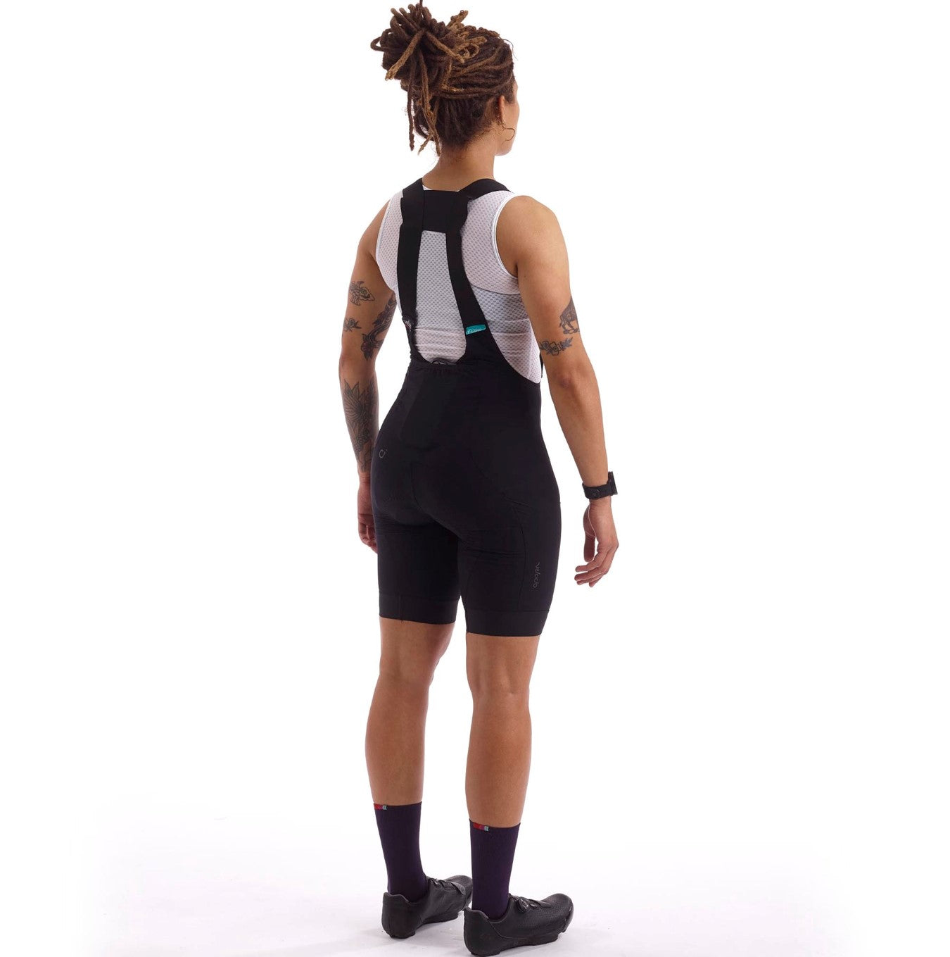 Efficient bib shorts designed for practical use, eliminating the need to remove layers during urgent pit stops.