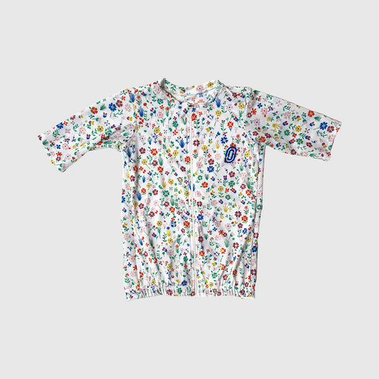 Floral-patterned baby onesie on a light gray background