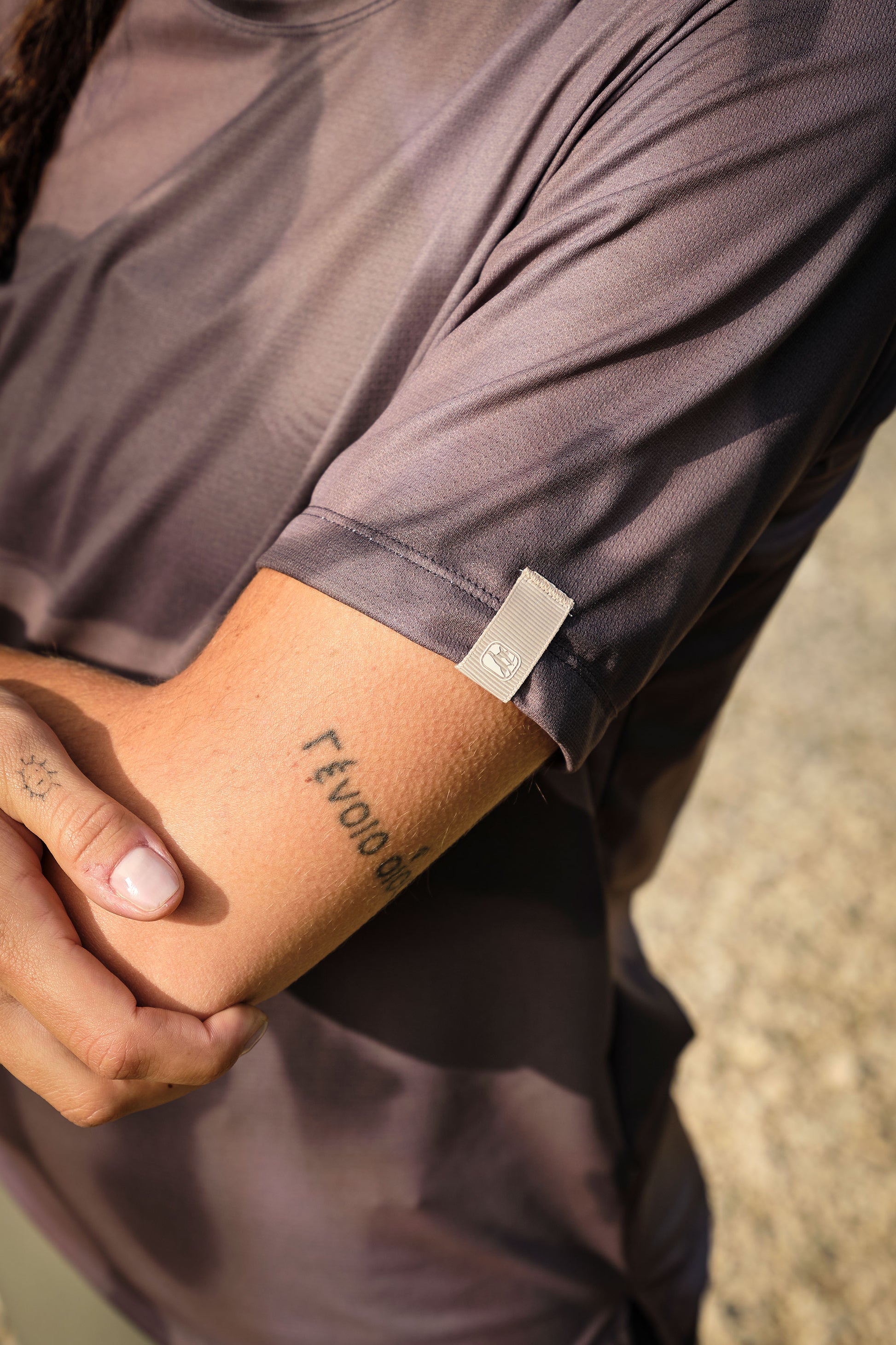 Flat lay of Beyond Gravel Tee Moonrock cassiopeia with accessories
