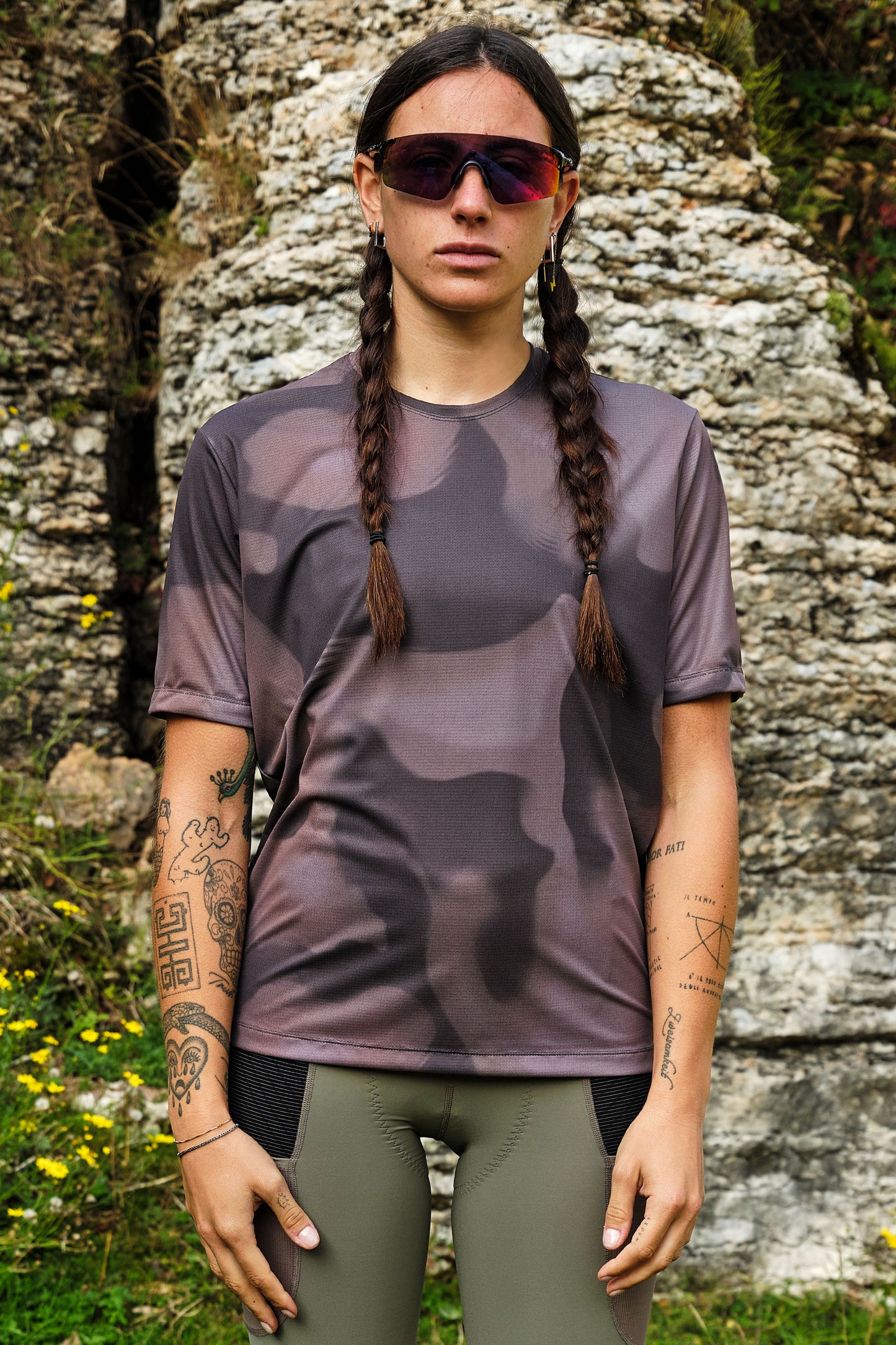 Outdoor lifestyle shot of model biking in Beyond Gravel Tee Moonrock cassiopeia