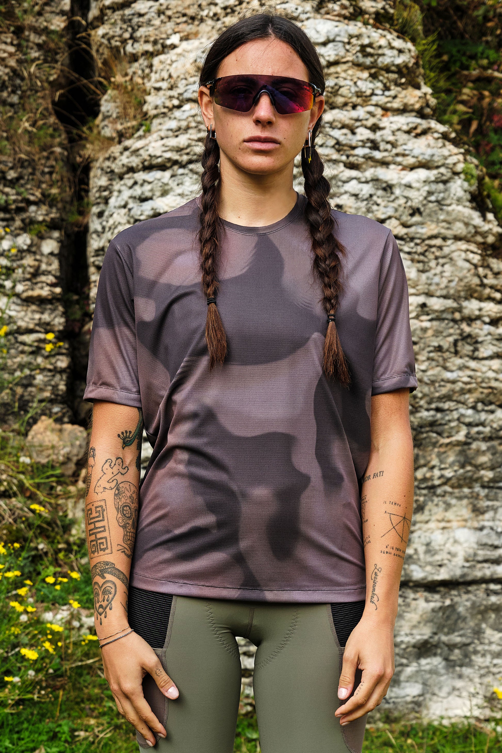 Outdoor lifestyle shot of model biking in Beyond Gravel Tee Moonrock cassiopeia