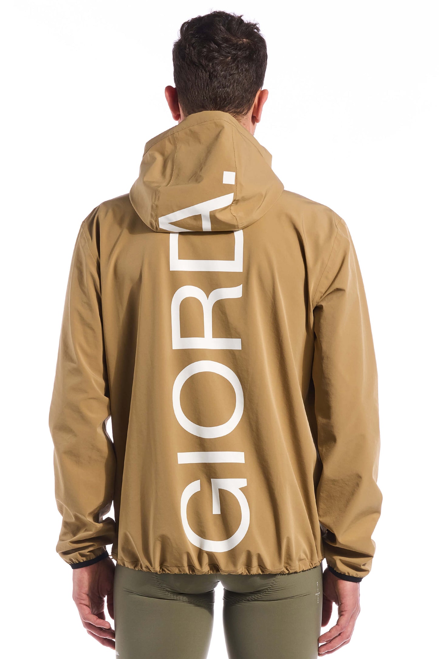 Image highlighting the drawstring hood and waist of the Jetty Rain Jacket, allowing for a customizable fit to keep you protected from the rain, available on Cassiopeia US.