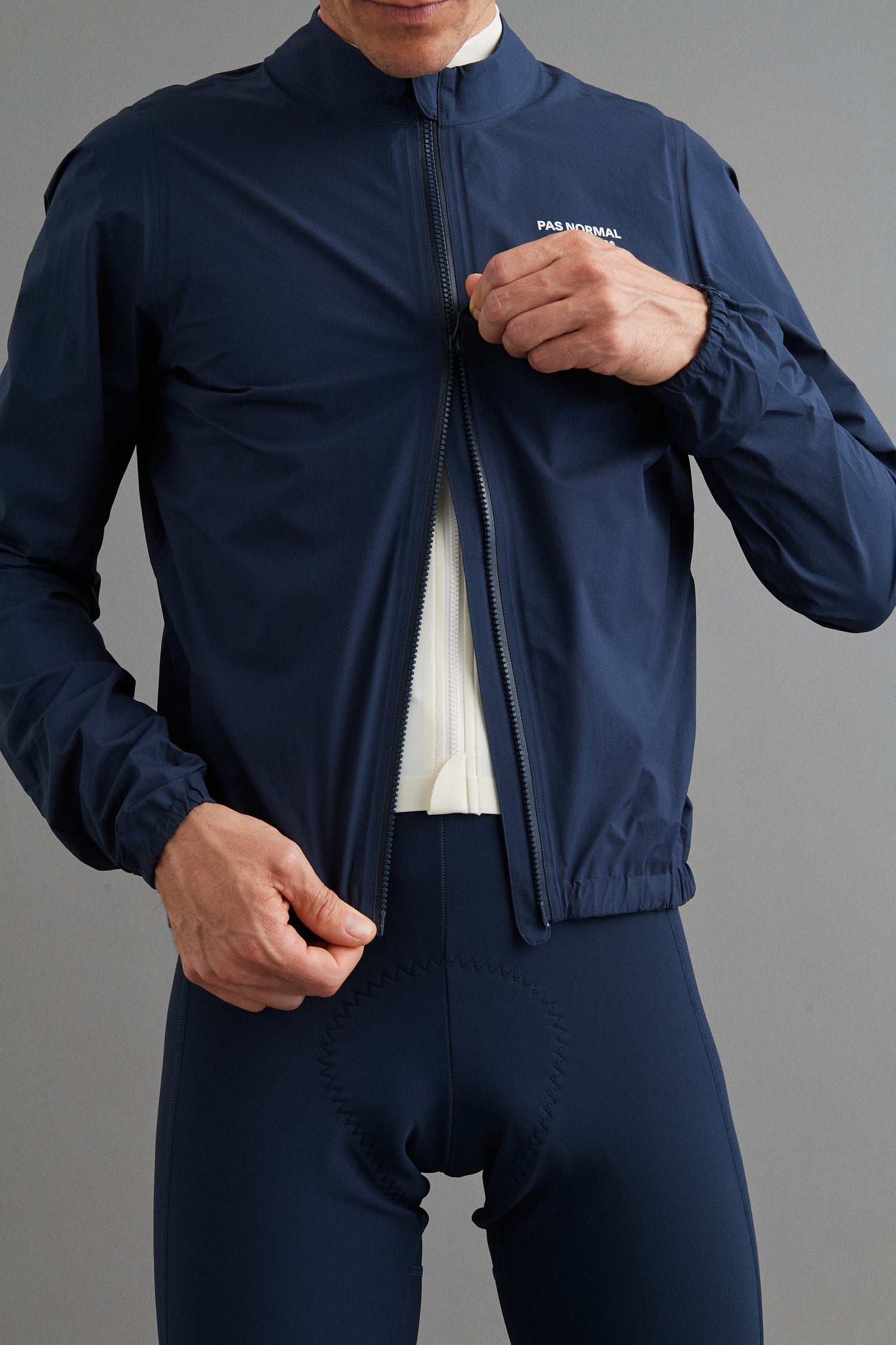 Close-up of Men's Mechanism Pertex Rain Jacket Navy two-way waterproof zipper for easy access