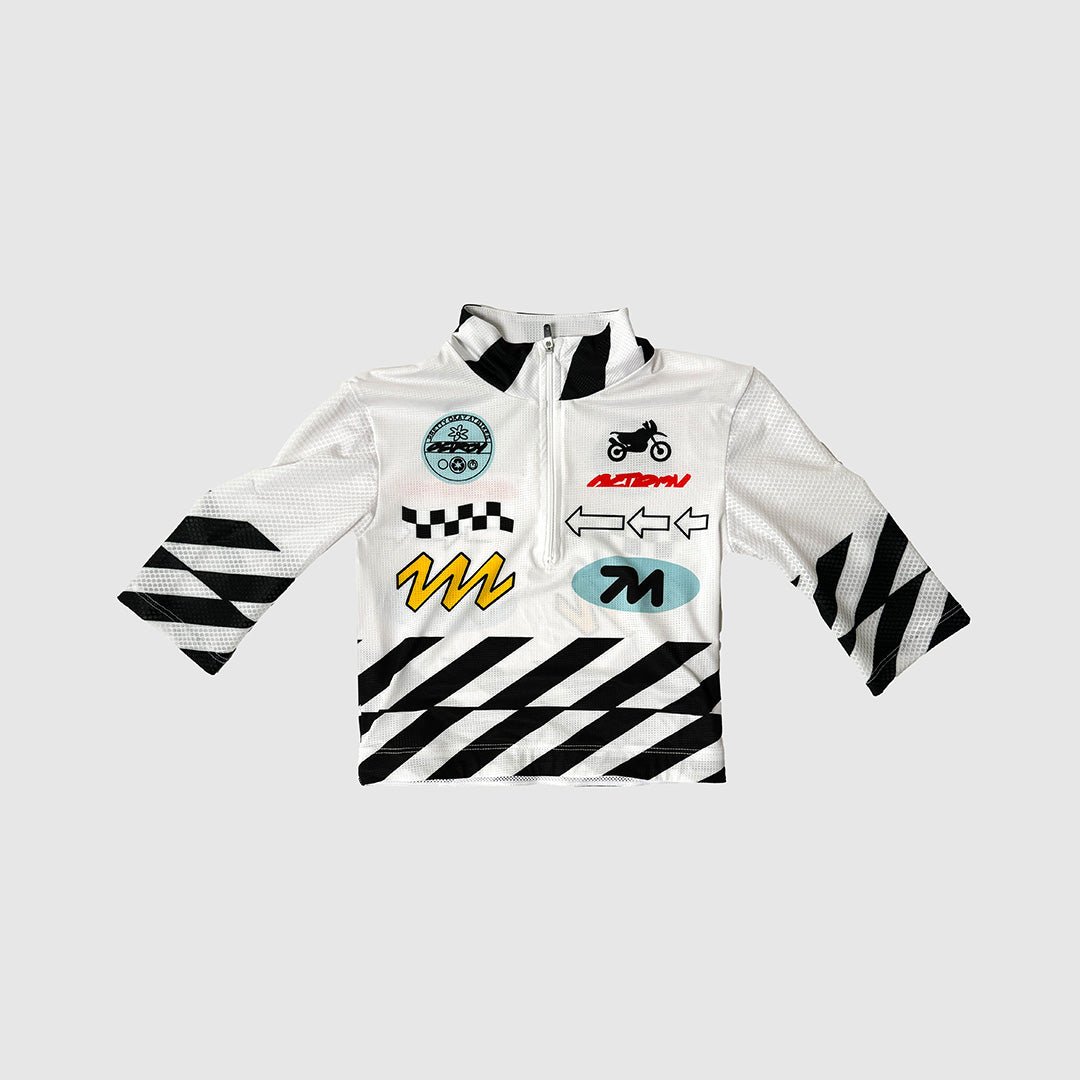 Minimo Jersey - Moto, showcasing its cropped design and performance mesh sleeves.