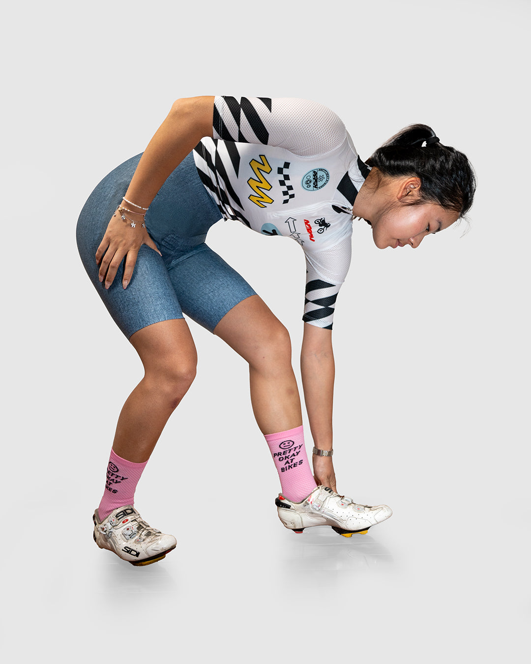 Minimo Jersey - Moto paired with cycling shorts, emphasizing its sporty yet stylish look.