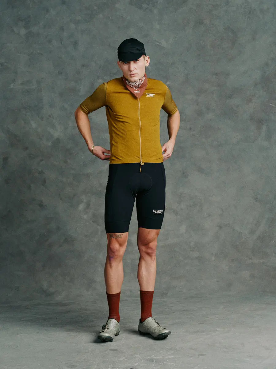 Cyclist wearing the PNS Escapism Bibs - Black, perfect for adventure rides and bikepacking.