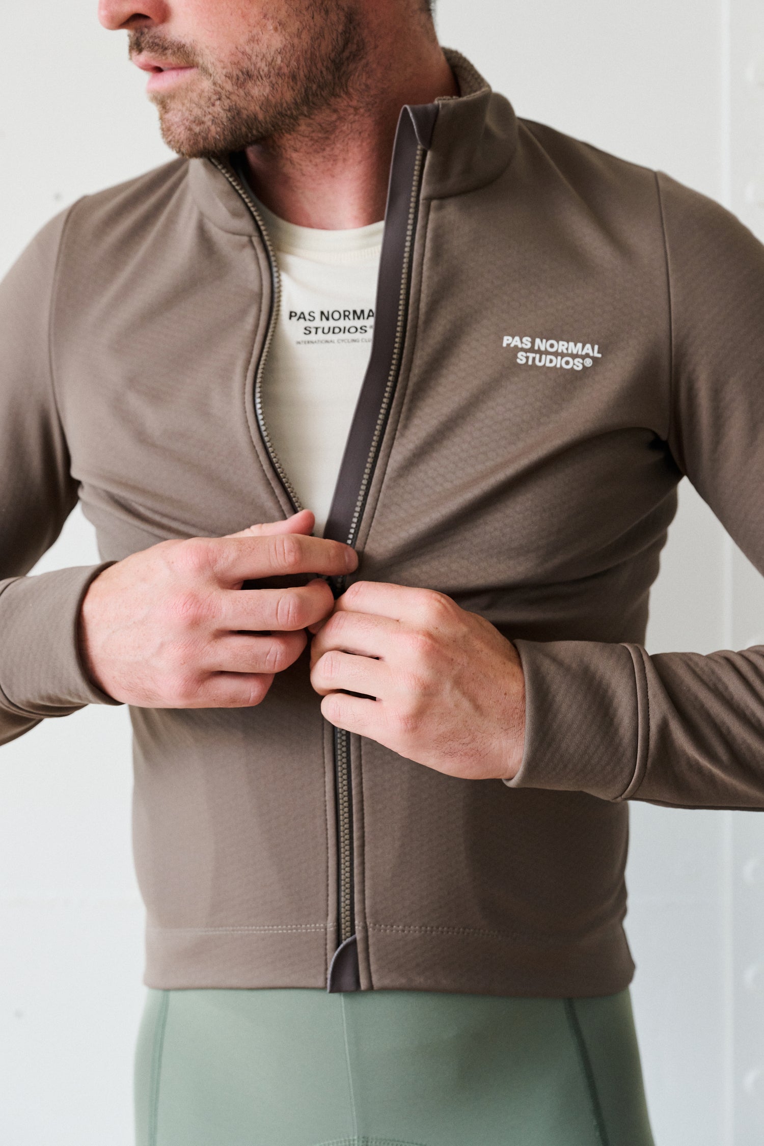 Cyclist wearing the Essential Thermal Long Sleeve Jersey - Ash Brown, perfect for chilly rides.
