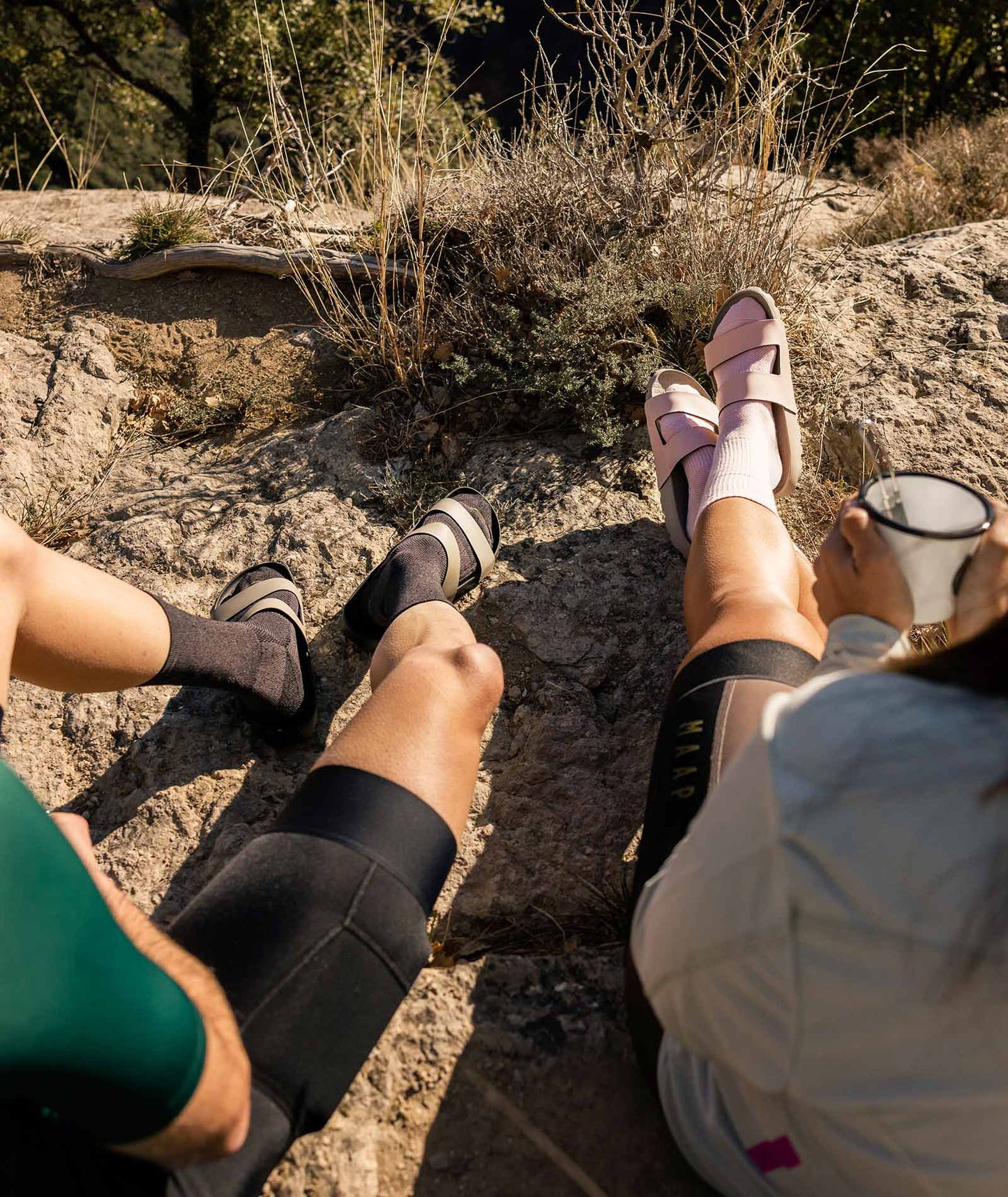 tourist wearing the Lala Slide - Sand, perfect for post-ride relaxation.