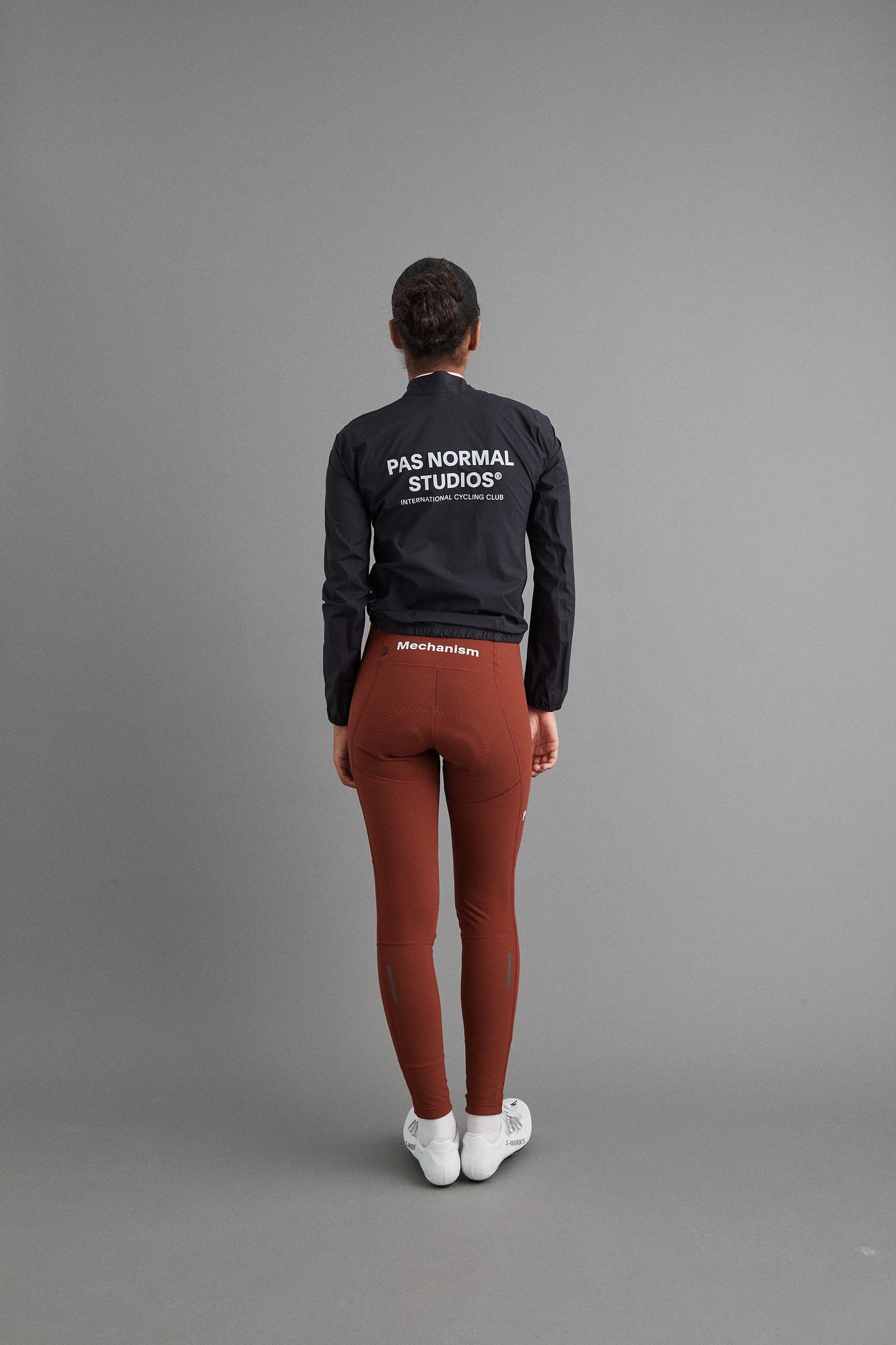 Back view of Women's Mechanism Rain Jacket Black on model, emphasizing lightweight and packable features