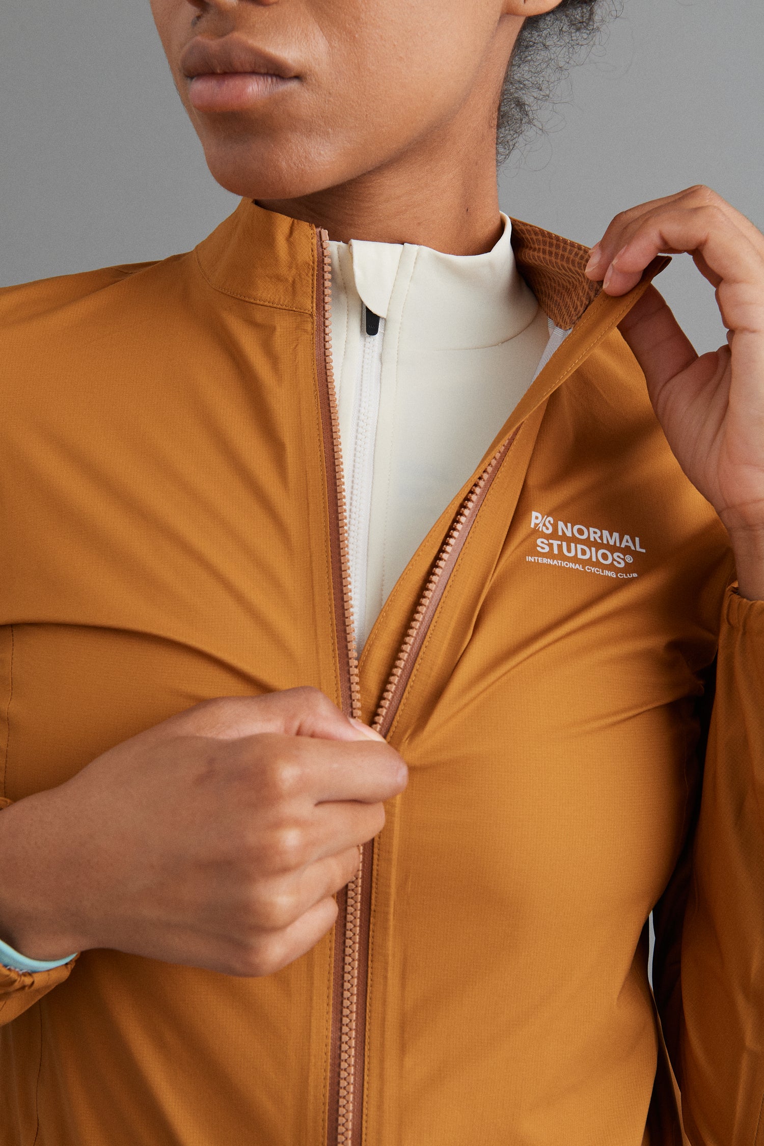 Jacket packed in jersey pocket, demonstrating portability for cycling adventures