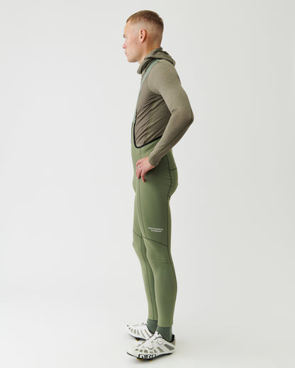 Person wearing a green tracksuit with a white background