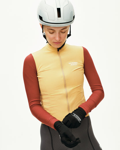 Person wearing a yellow vest, red long-sleeve shirt, gray pants, and black gloves with a white helmet on a white background.