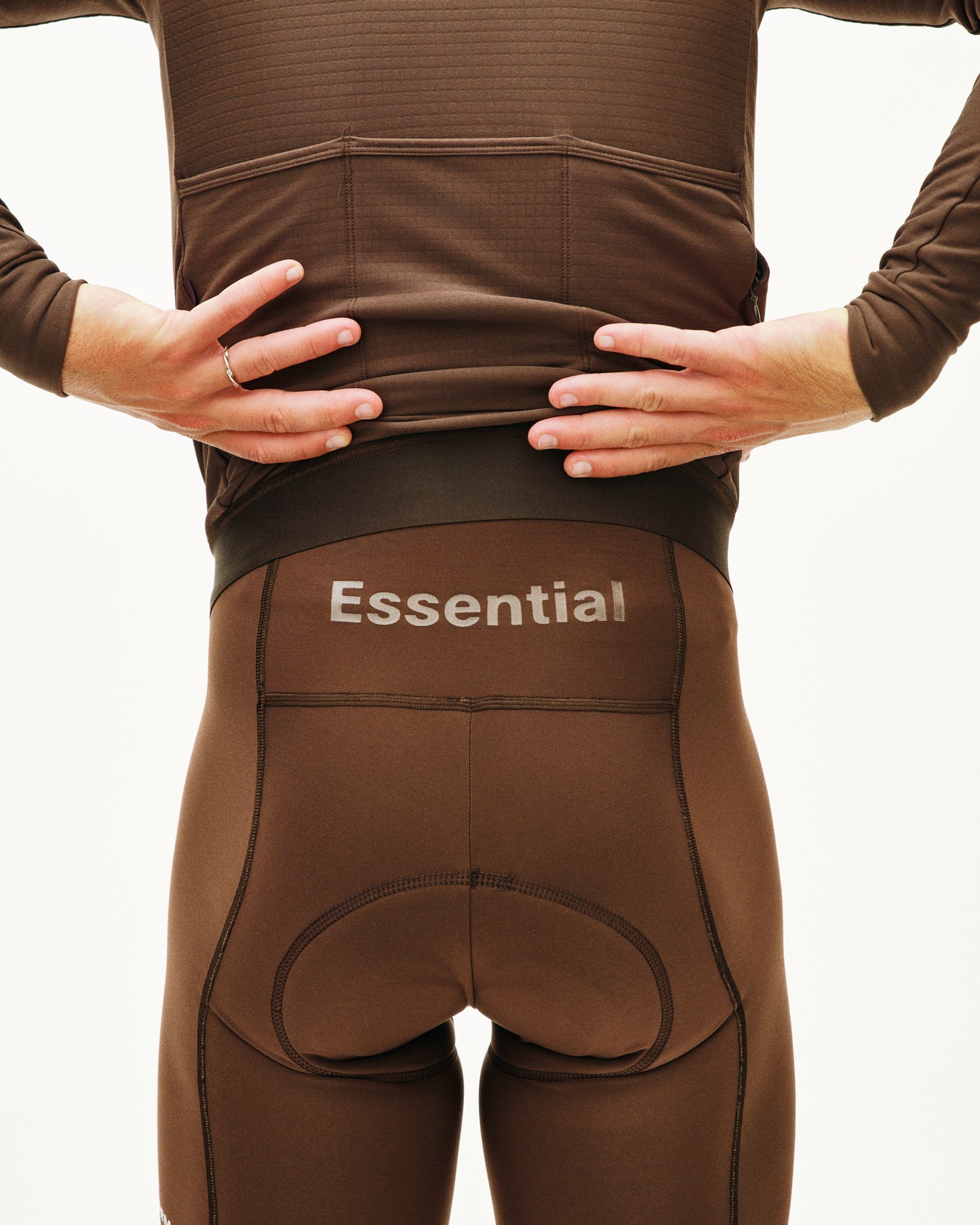Brown compression garment with 'Essential' branding on a plain background