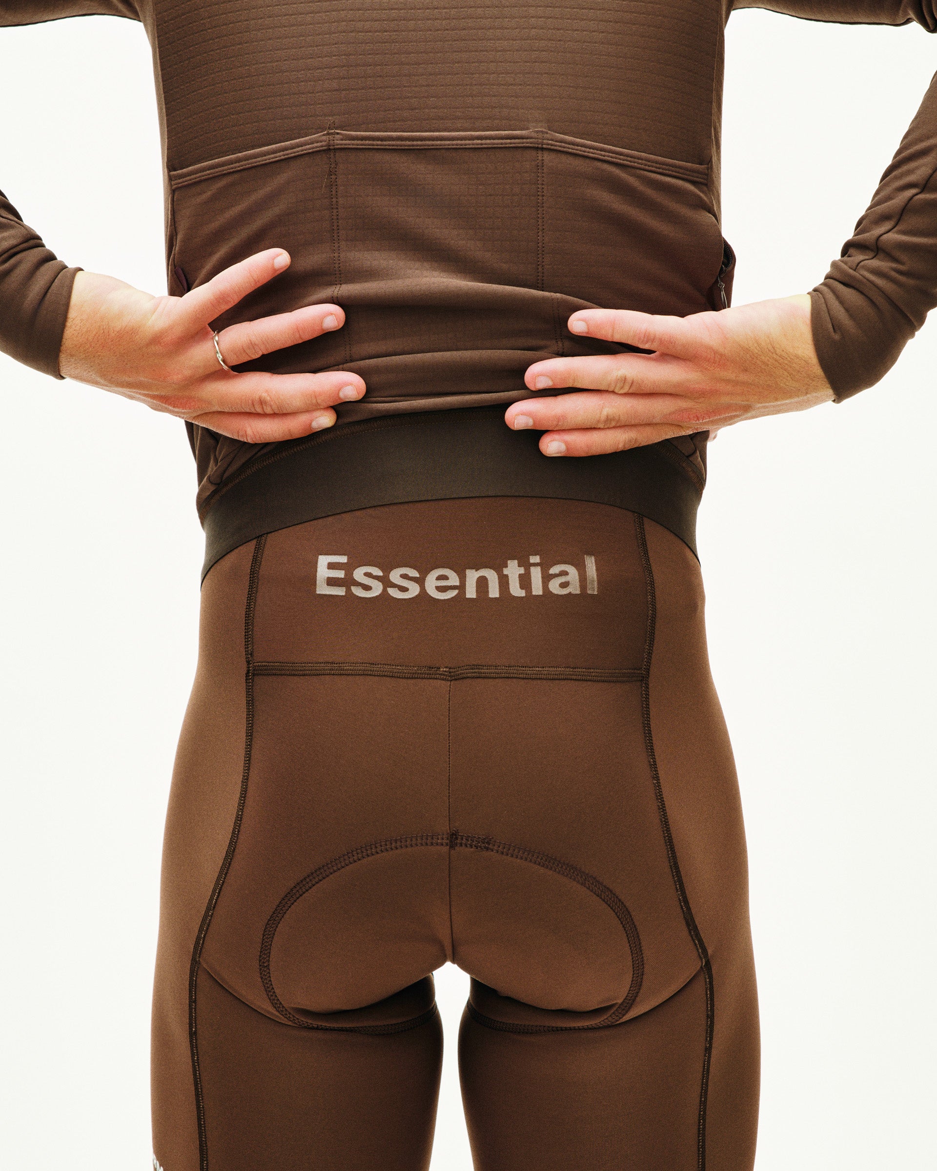 Brown compression garment with 'Essential' branding on a plain background