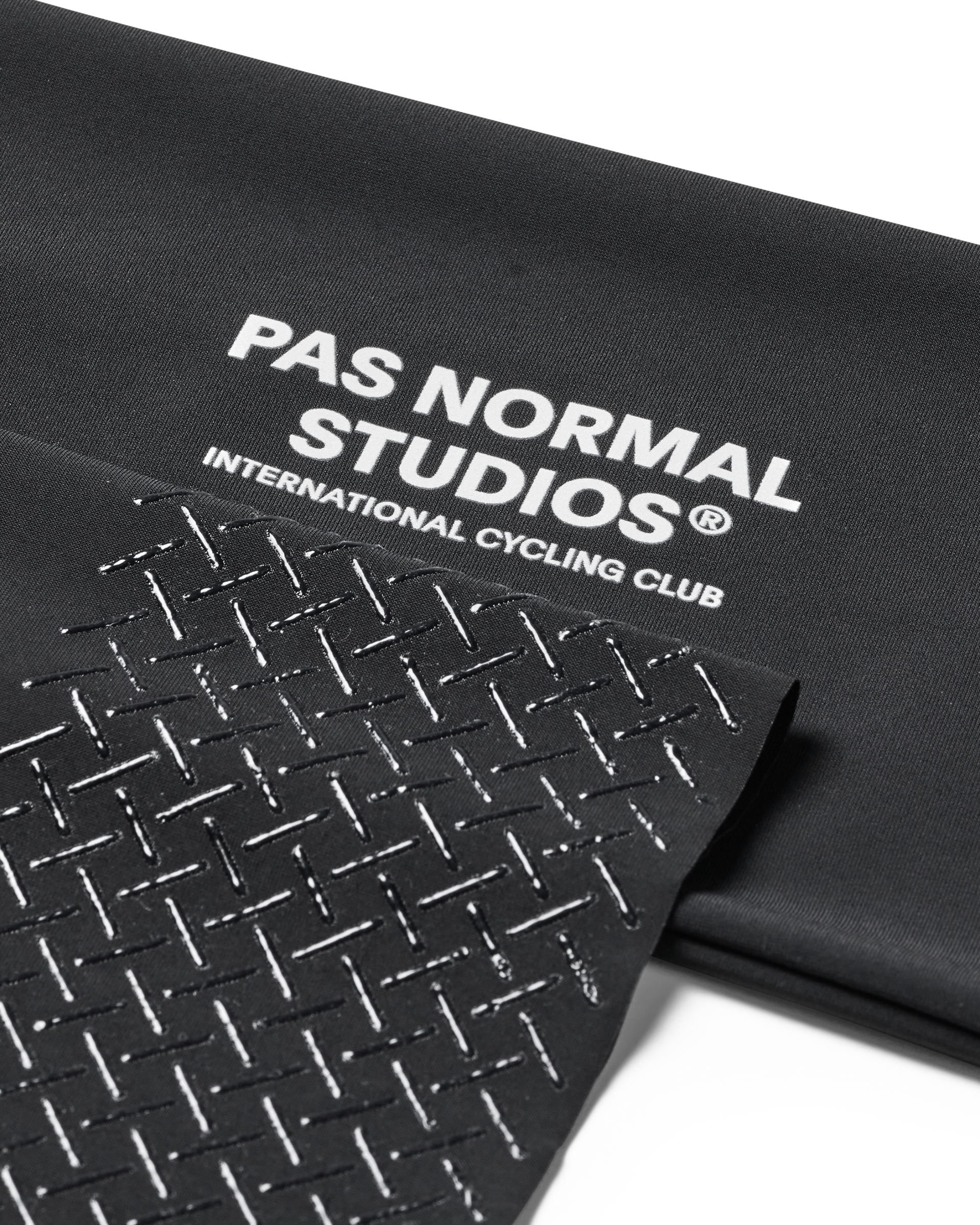Black mat with 'Pas Normal Studios' branding on a white background