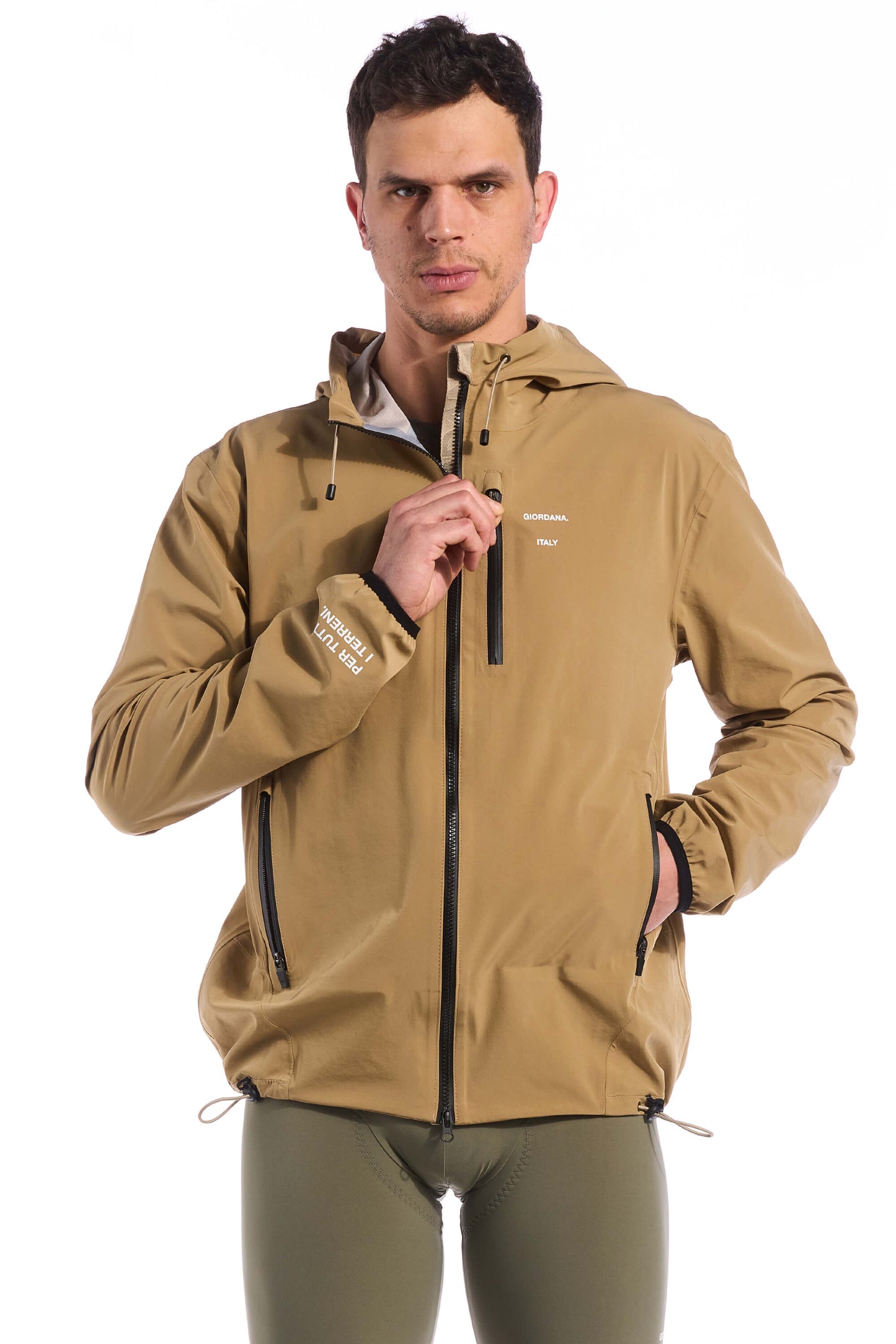 Image of the front chest pocket on the Khaki Jetty Rain Jacket, designed for convenient storage while cycling or during outdoor activities, available on Cassiopeia US.
