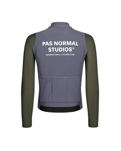 Gray and green cycling jacket with 'Pas Normal Studios' branding on the back.