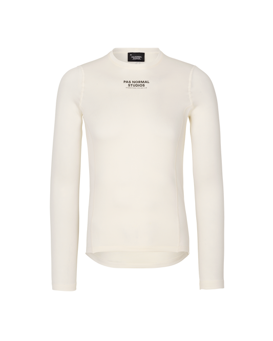 White long-sleeve shirt with 'Pas Normal Studios' logo on a white background
