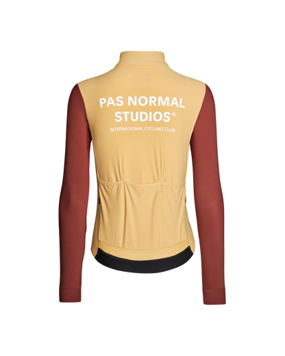 Beige cycling vest with red sleeves and 'Pas Normal Studios' branding on a white background