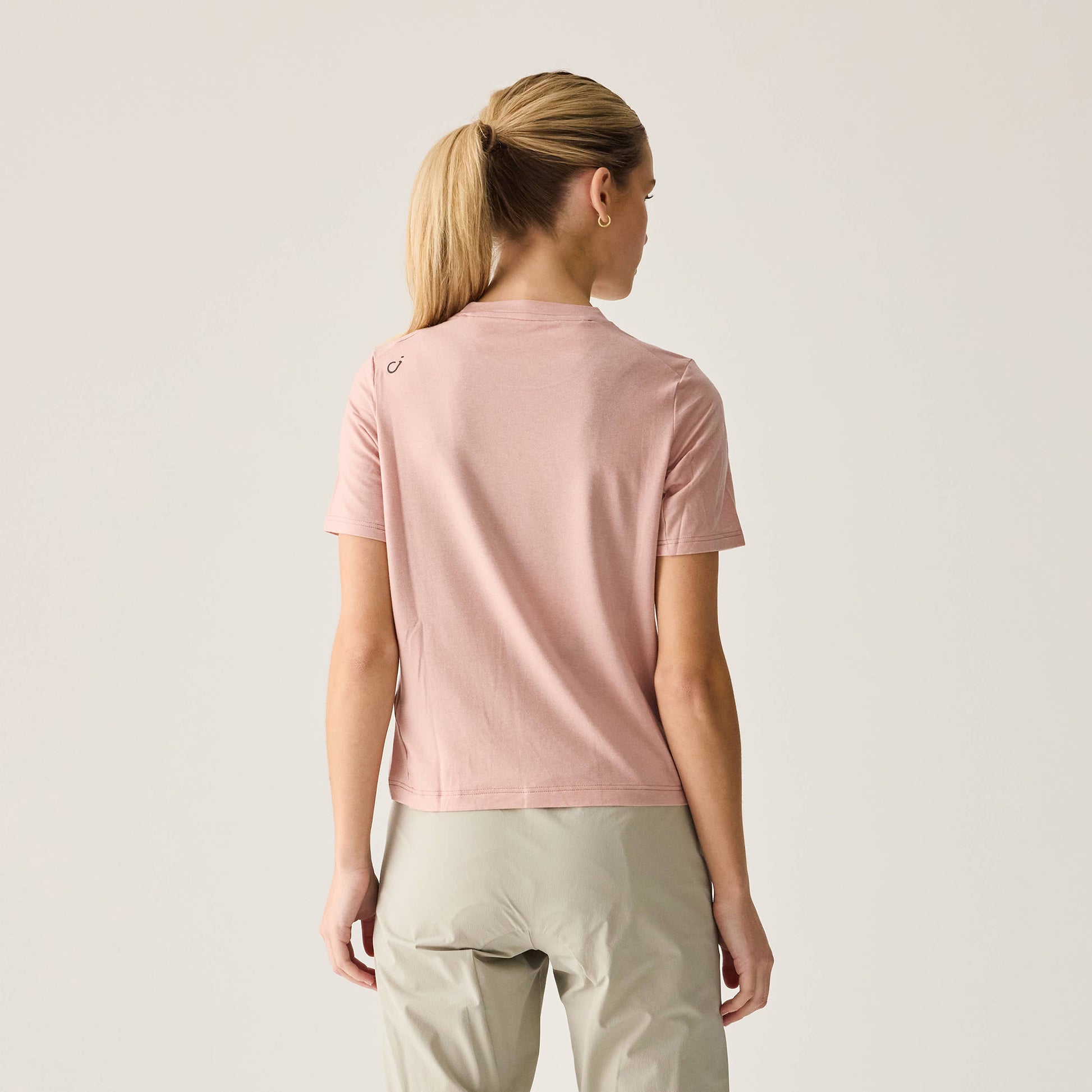 Back view of Women's Merino Ride Tee in soft Misty Rose shade